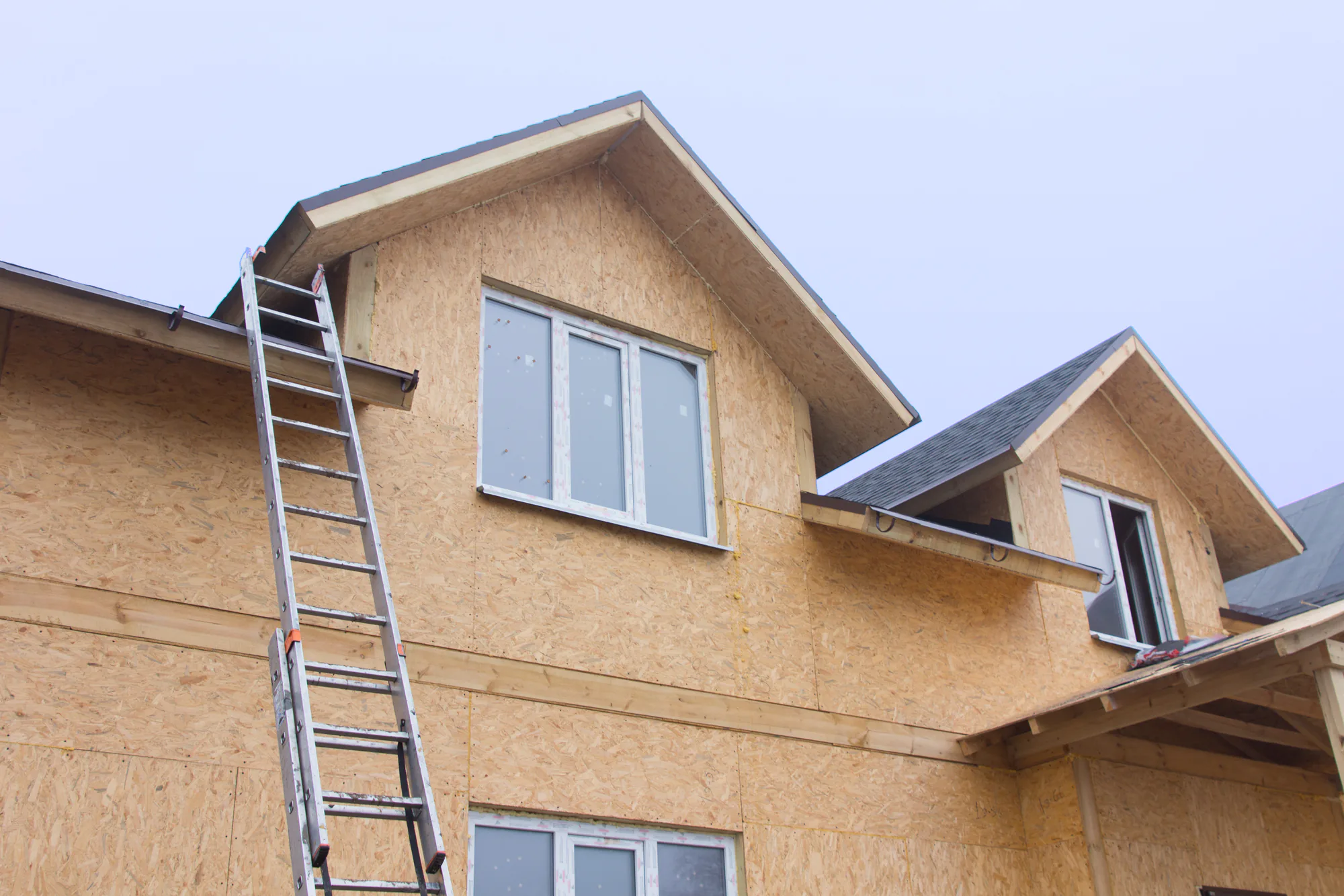 A home getting siding under construction