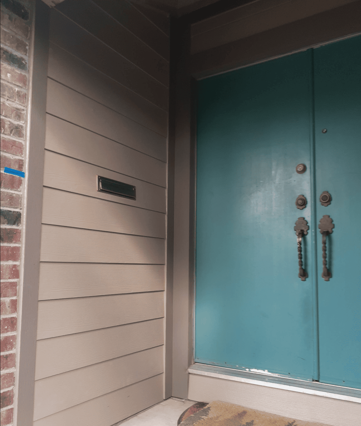 blue front door with beige siding